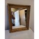 Wooden mirror and gold trim