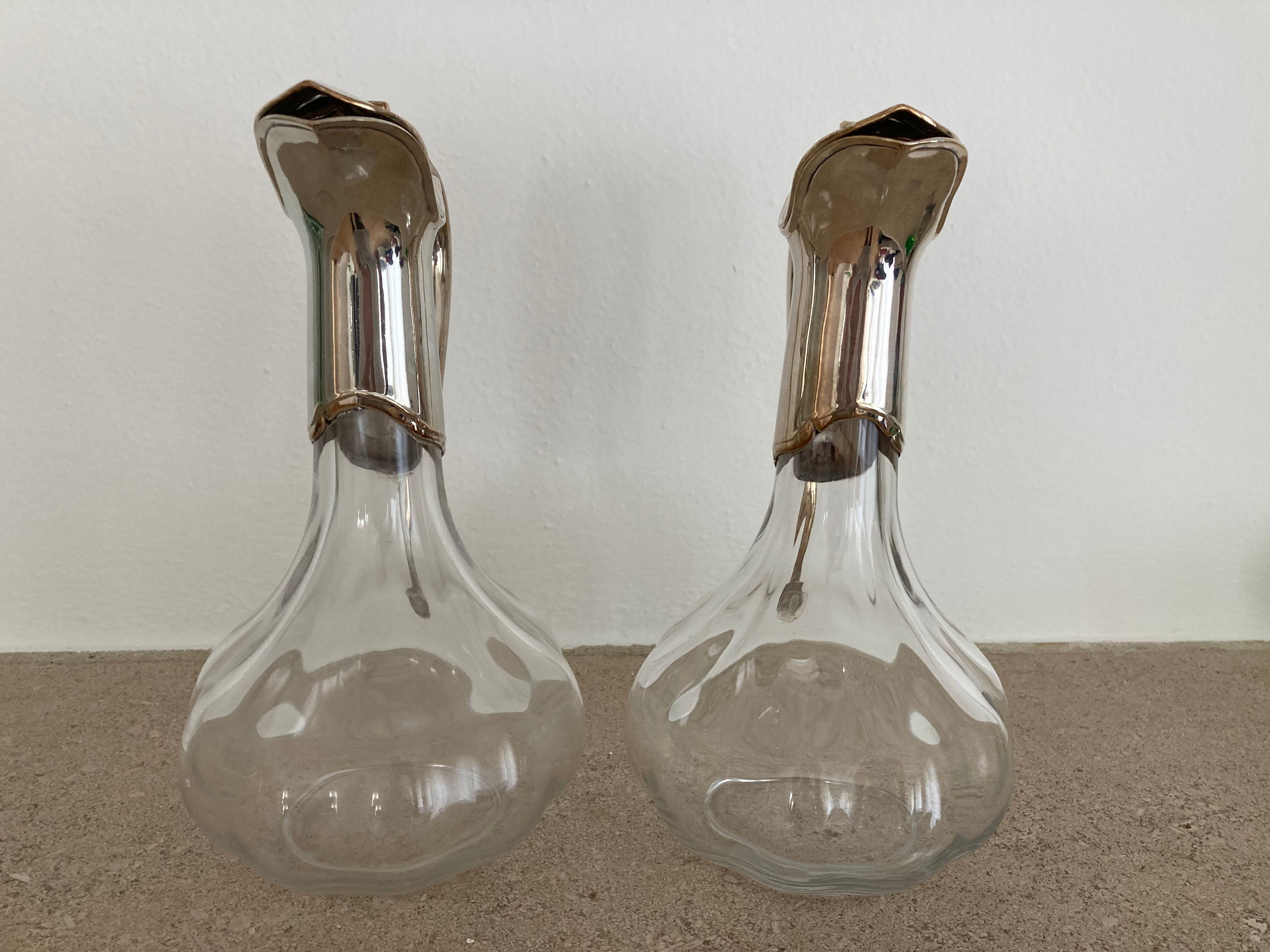 Glass decanters and silver metal spouts