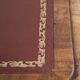 Antique English writing desk from the 19th century with a red leather top
