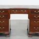 Antique English wooden desk from the late 19th century with a leather top
