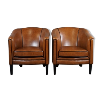 New set of two sheepskin leather armchairs with black piping