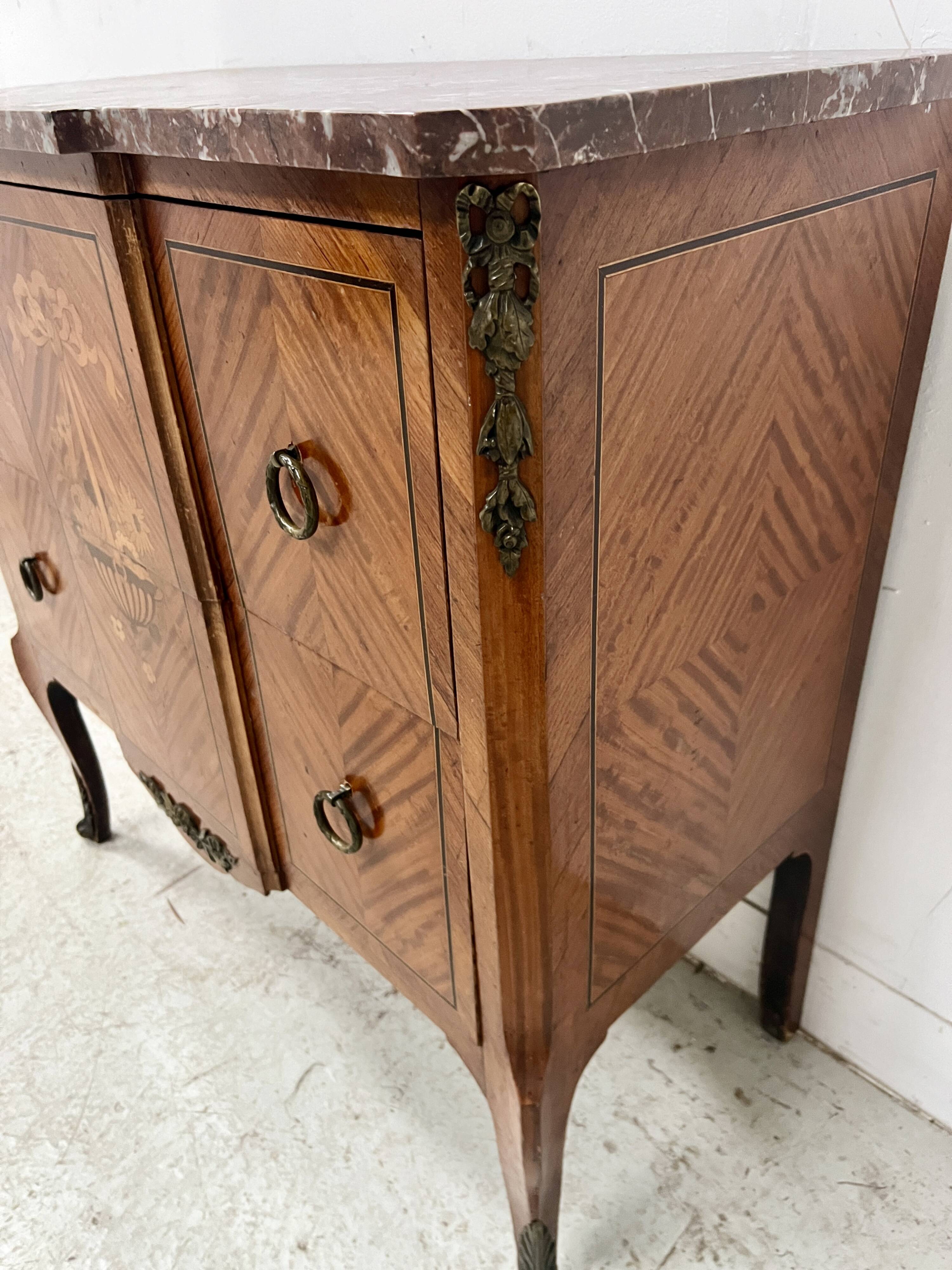 Transitional style commode with a protruding front, in marquetry wood, 20th century.