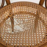 Bistro chair with curved wooden armrests and canning seat