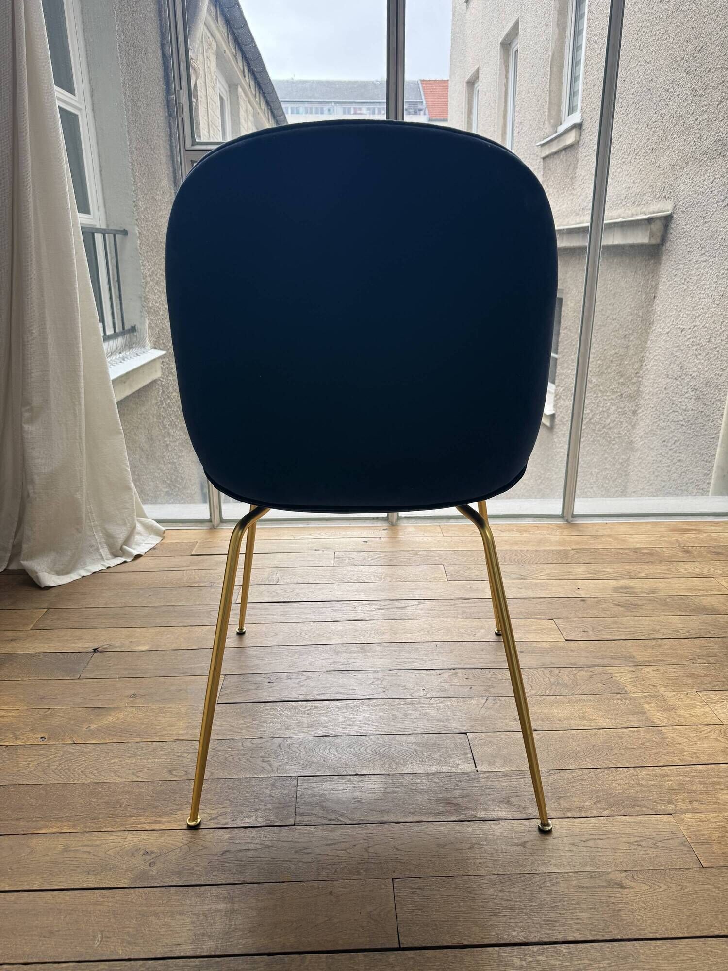 GUBI Beetle designer chair in midnight blue velvet with brass base