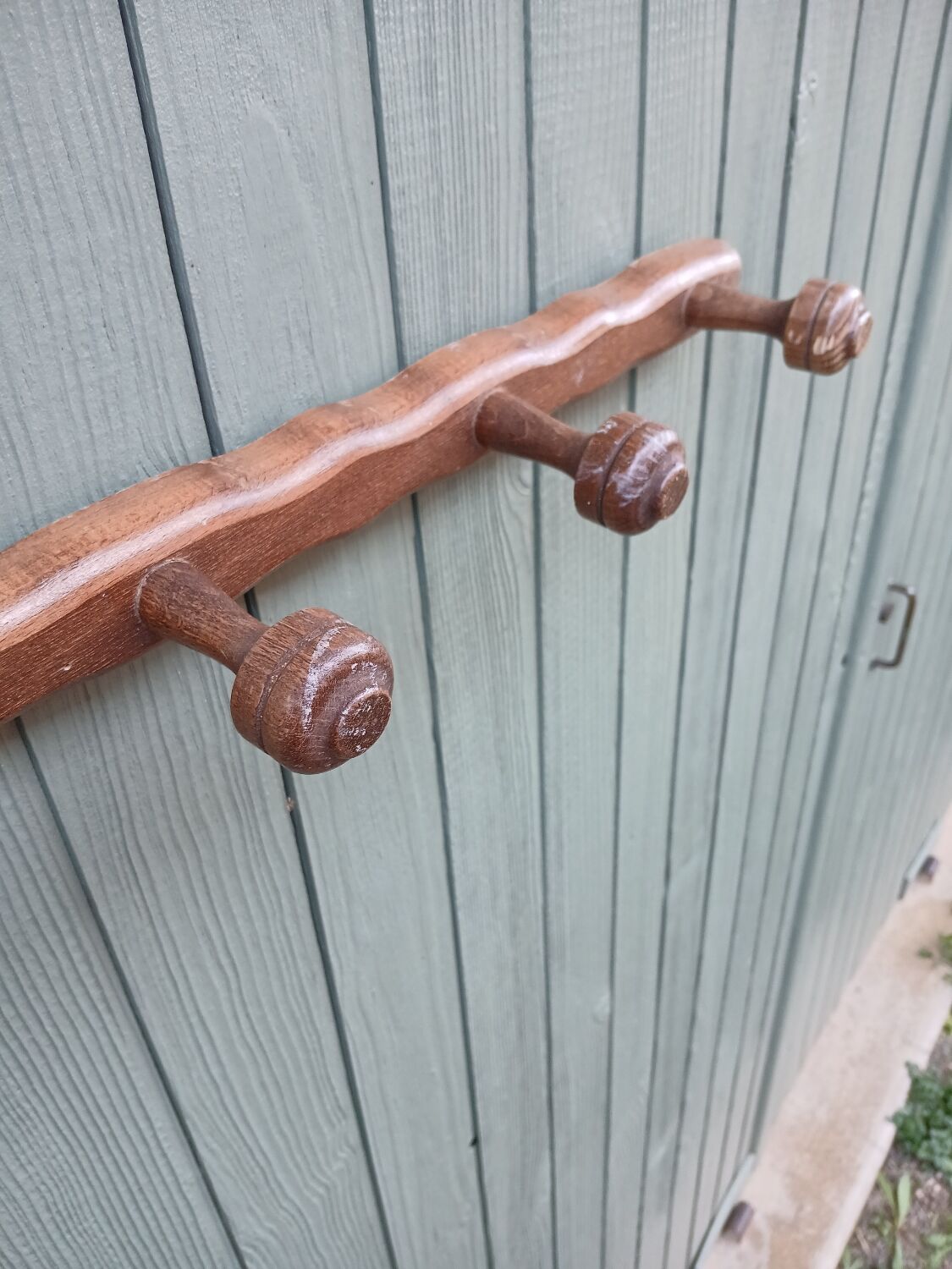 Small antique wooden wall coat rack.