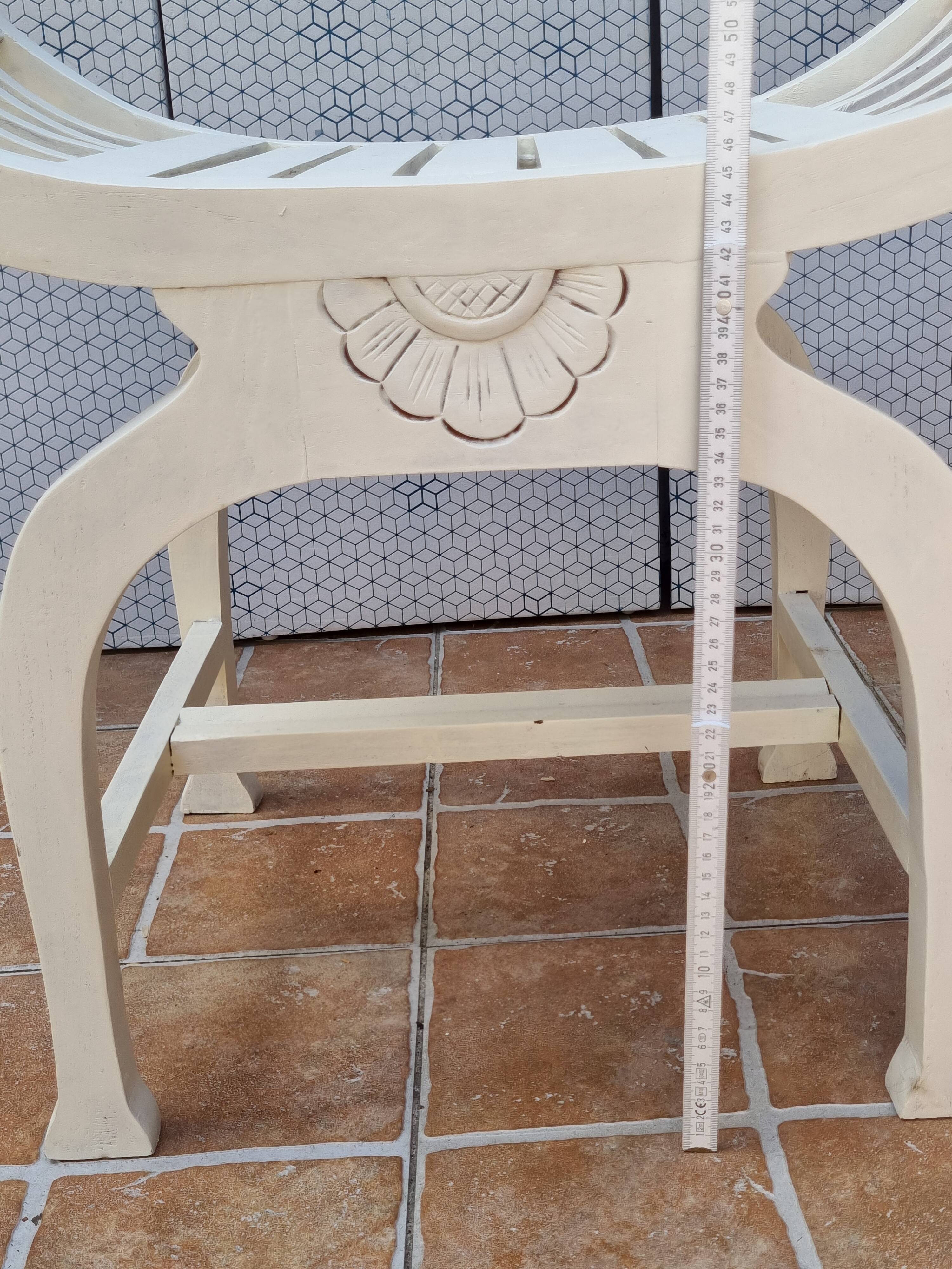 Curule stool in patinated carved wood, Manuel Canovas seat, 60 cm