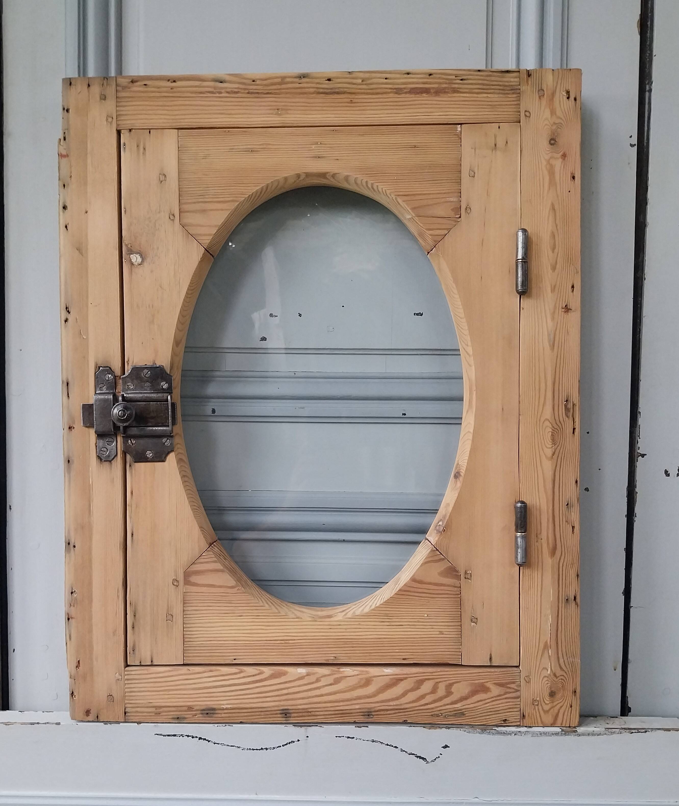 Old bullseye window with oval glass