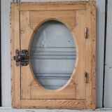 Old bullseye window with oval glass
