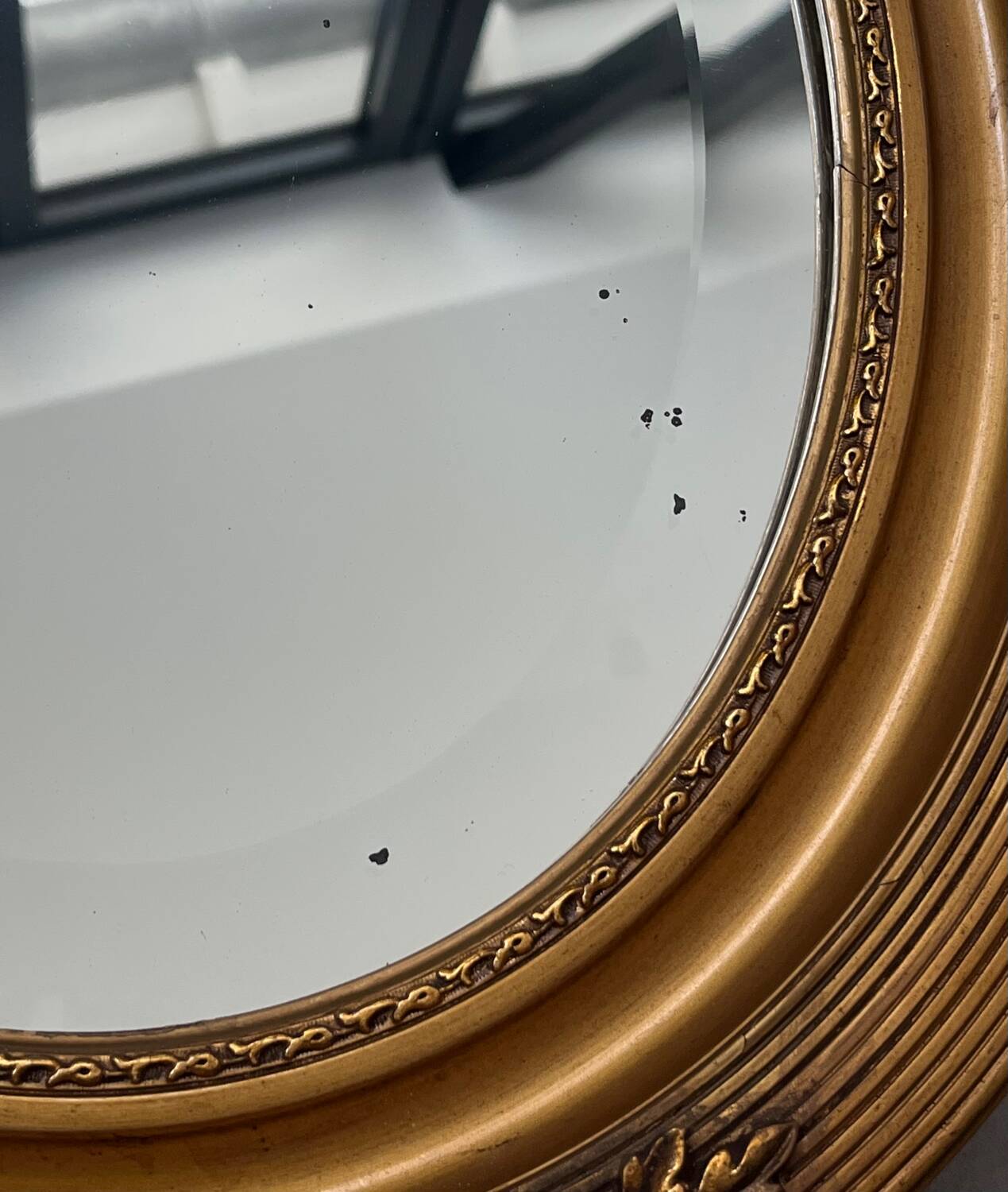 Oval gilt mirror and Art Deco trim