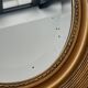 Oval gilt mirror and Art Deco trim