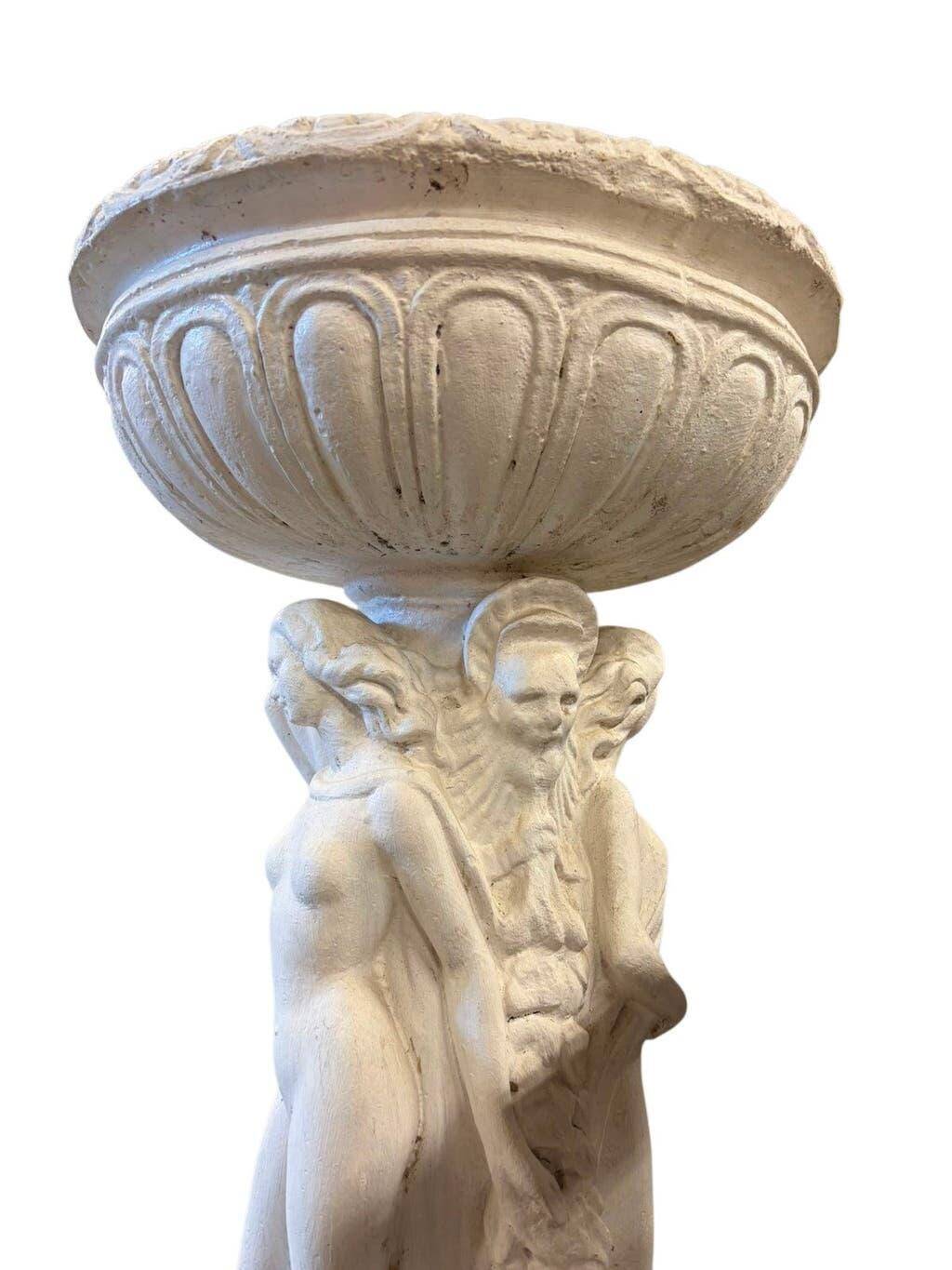 Vintage white concrete garden statue adorned with planter.