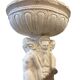 Vintage white concrete garden statue adorned with planter.