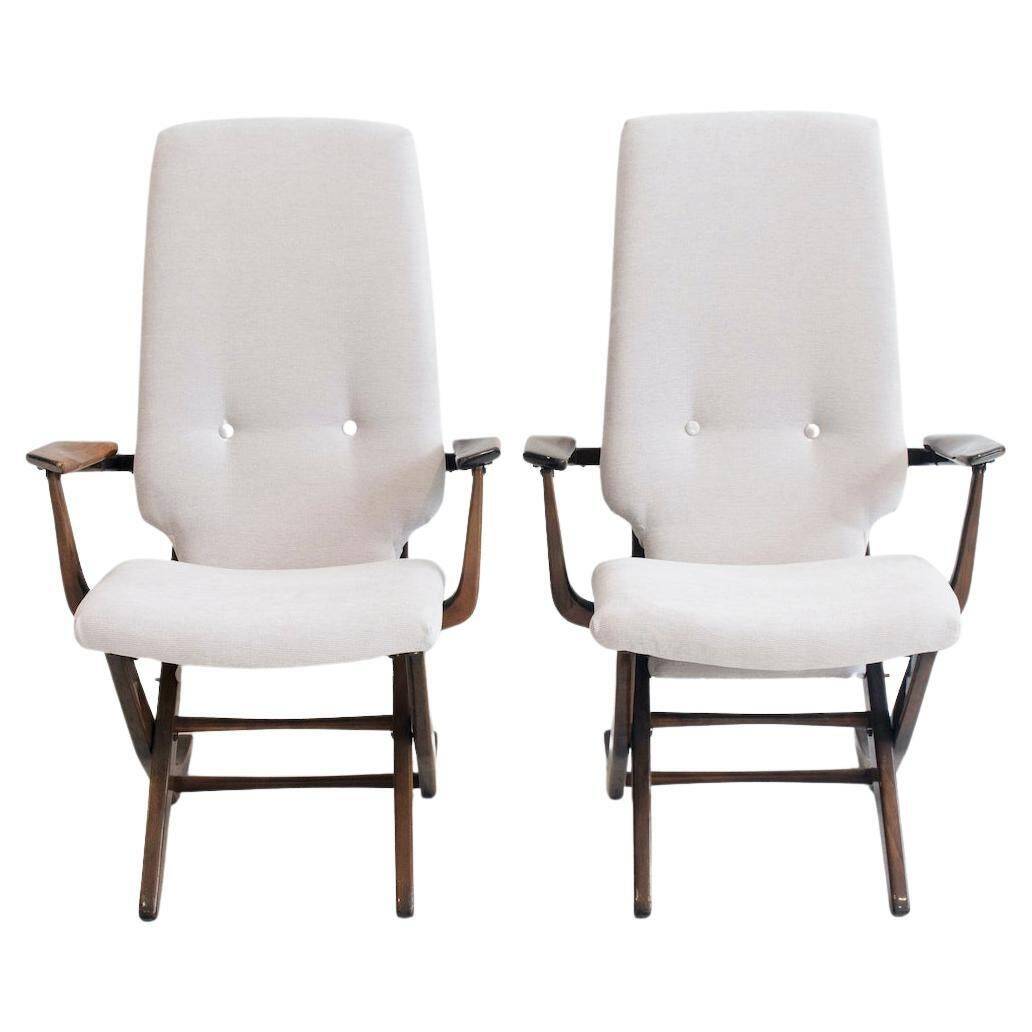 Pair of varnished wooden reclining armchairs, upholstered in lightweight fabric.