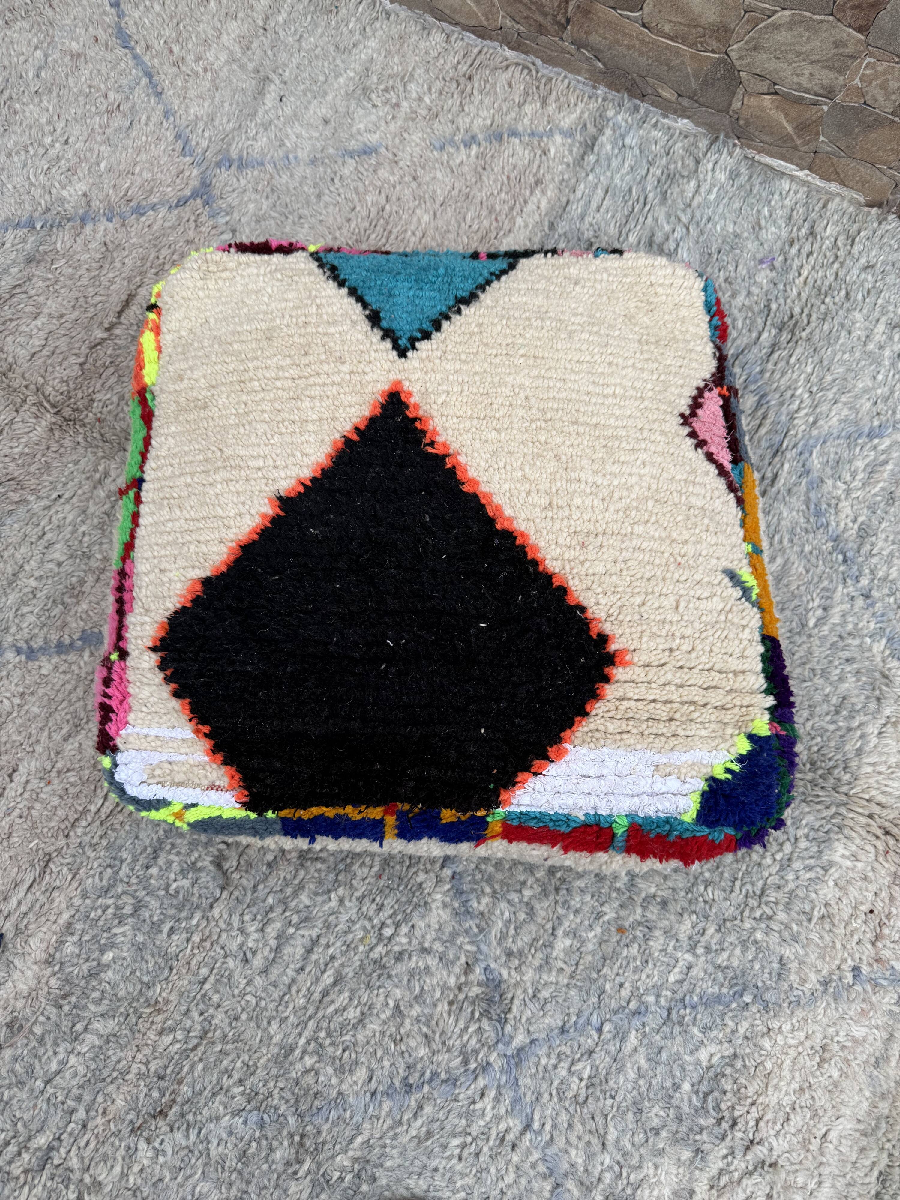 Berber floor pouf: Handwoven Moroccan wool cushion.