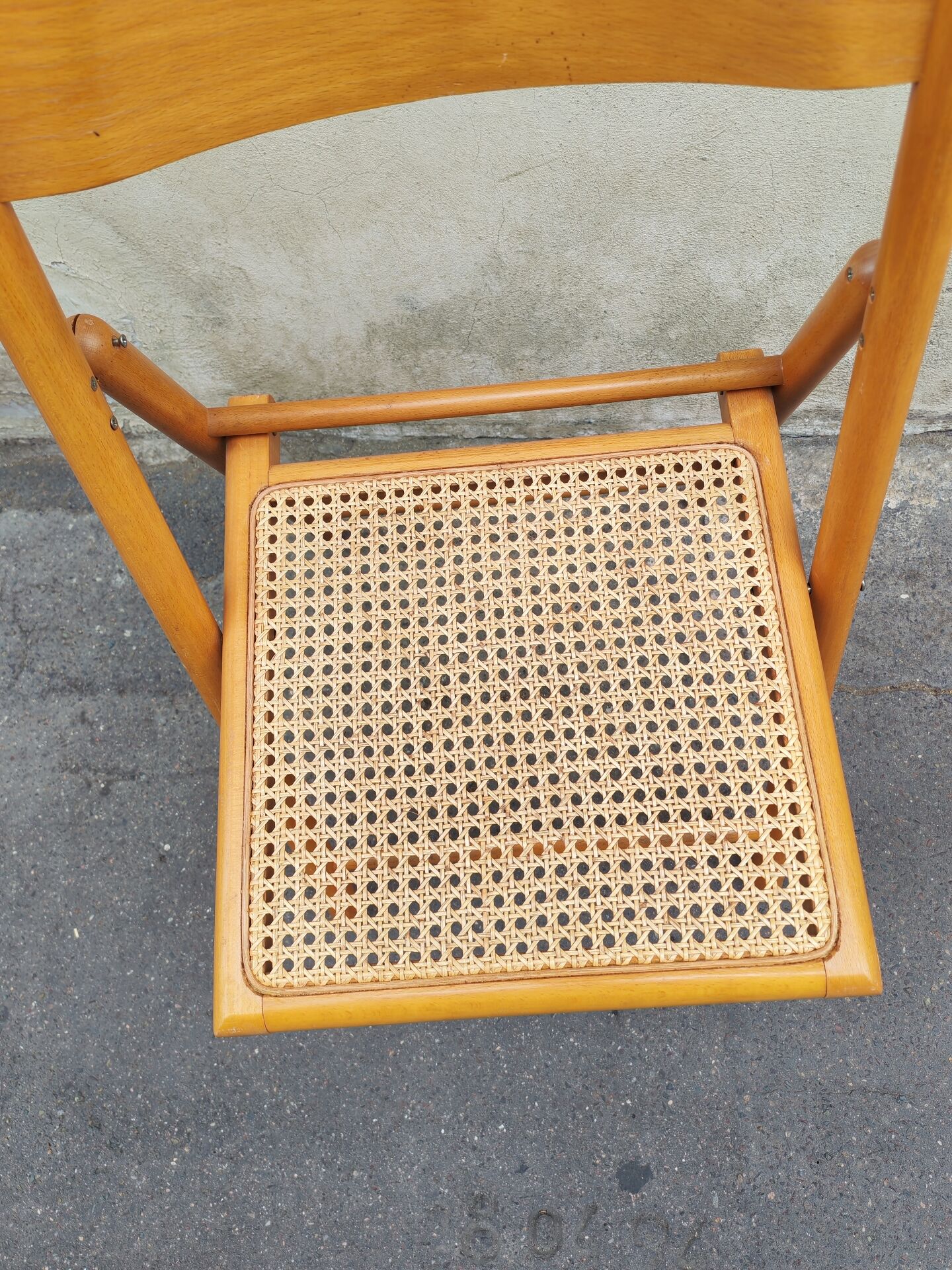 Wooden folding chair with caning from the 1980s.
