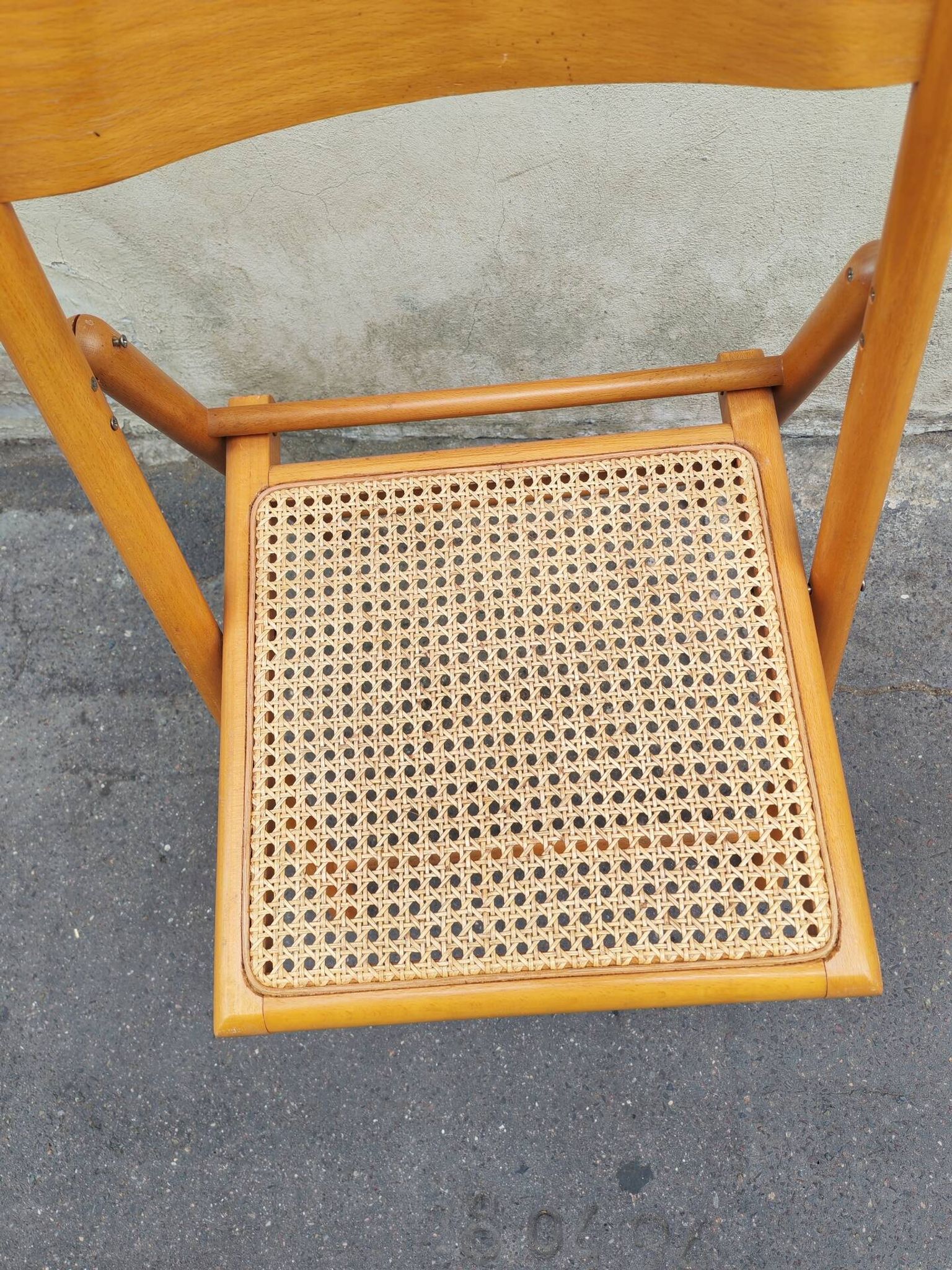 Wooden folding chair with cane from the 1980s.