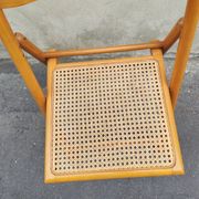 Wooden folding chair with cane from the 1980s.