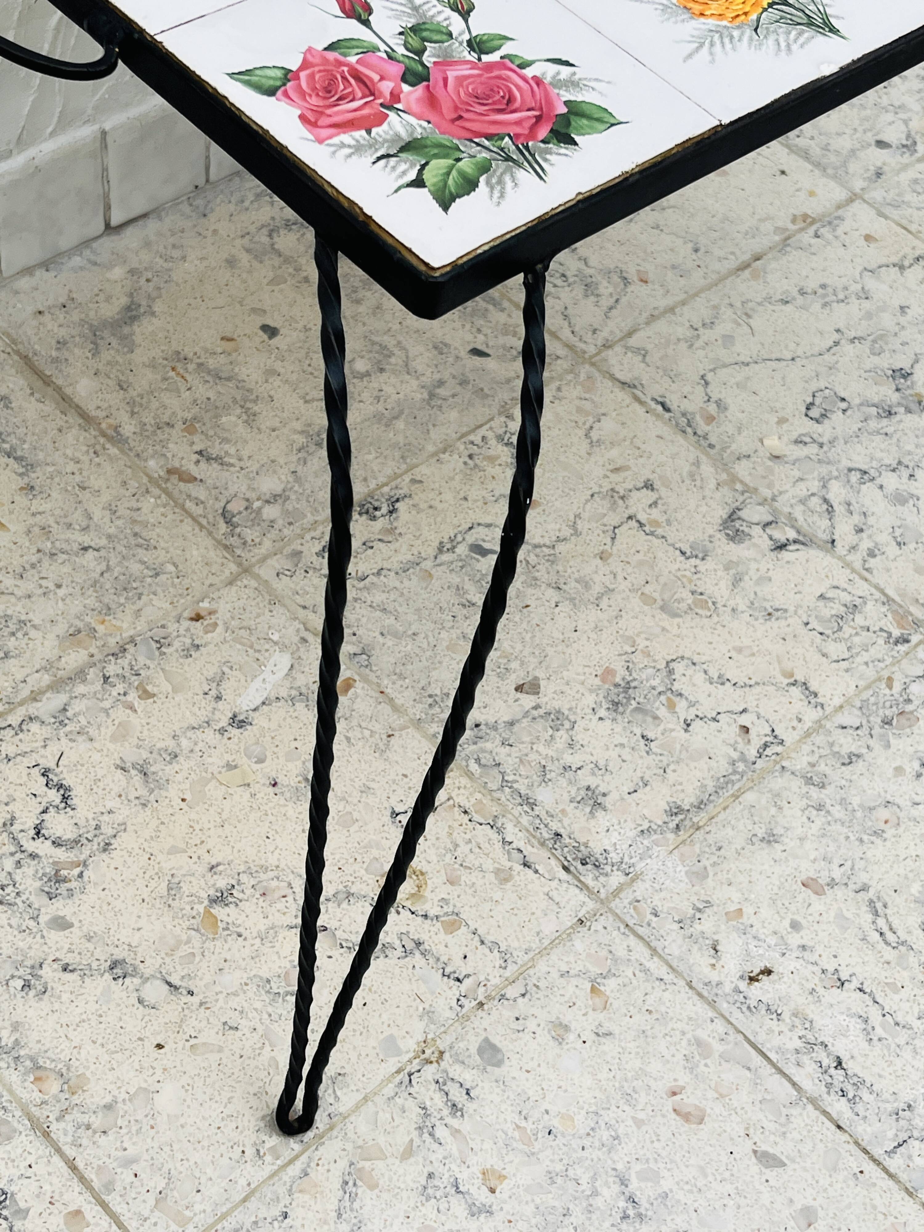 Vintage coffee table in wrought iron with floral tiles.