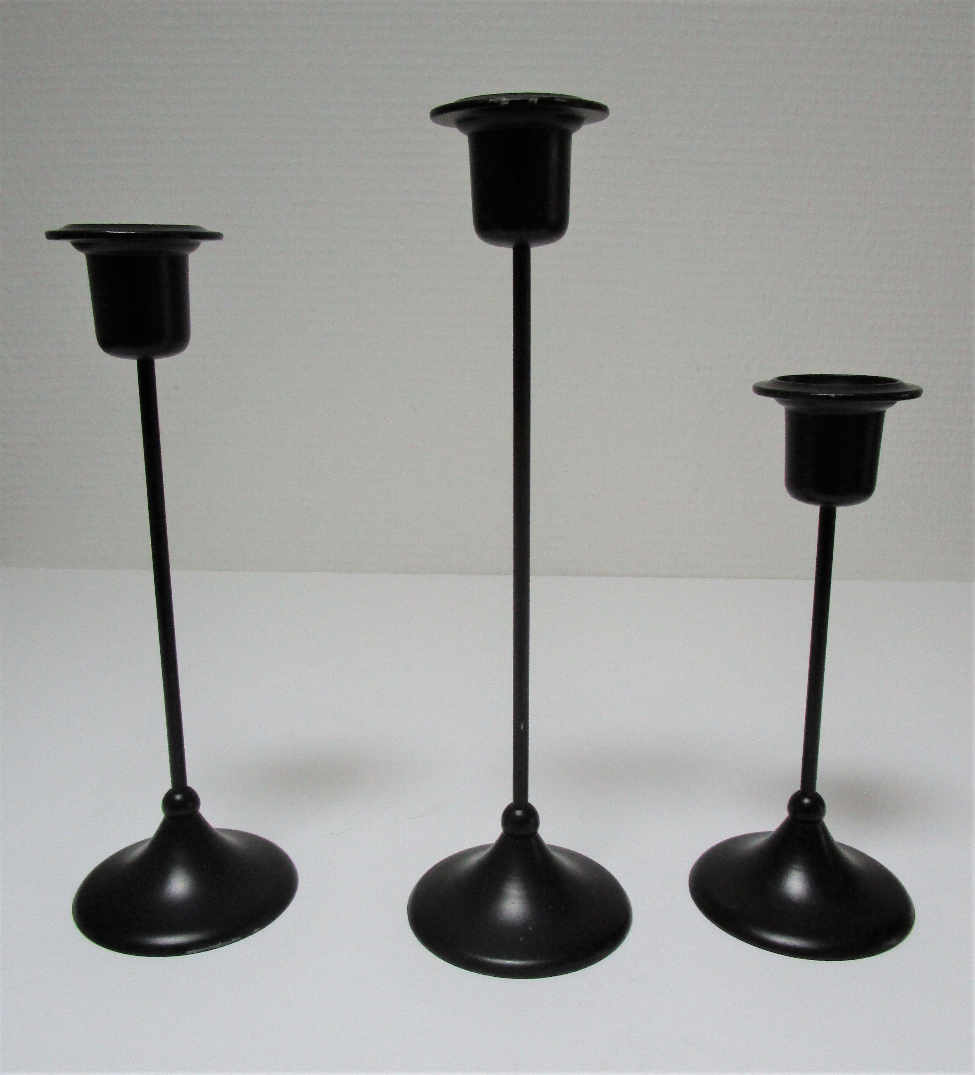 Three Scandinavian black lacquered metal candle holders