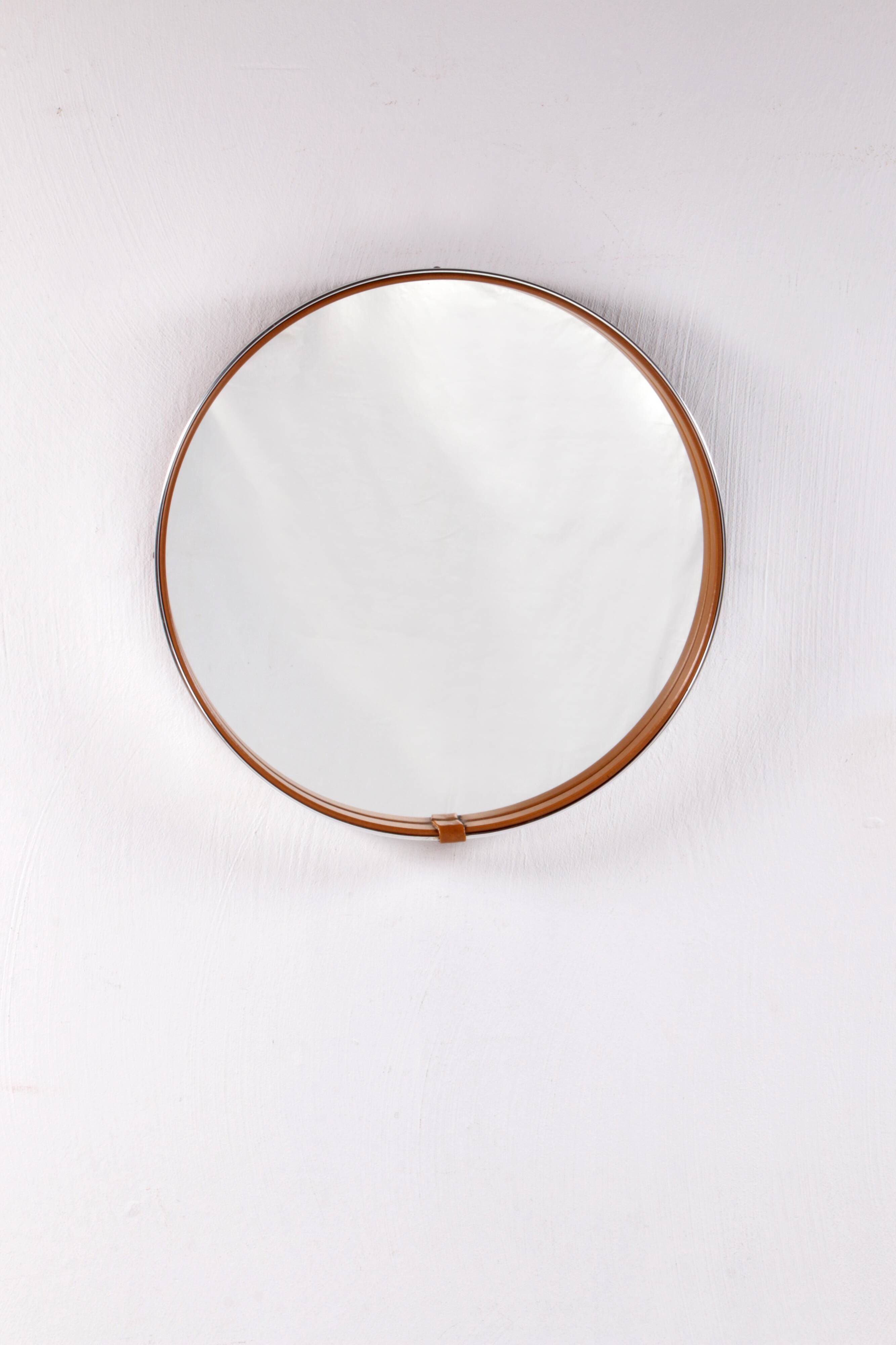 Round mirror covered with leather and chrome, made in France in the 1970s.