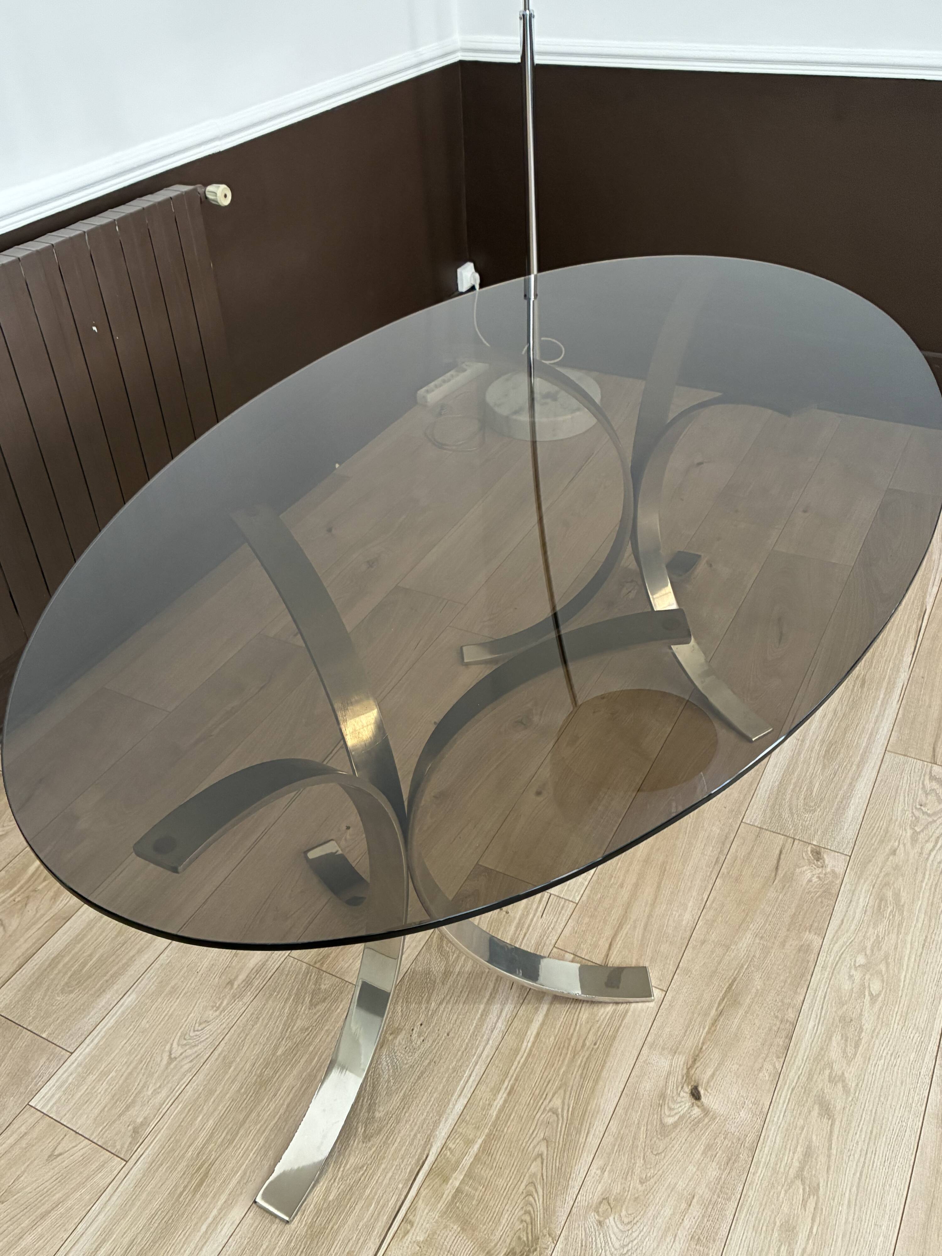 Smoked glass table with a metal base.
