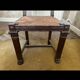 Antique carved wooden chairs with straw seats.