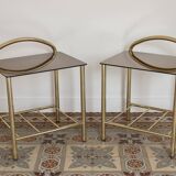 Pair of bedside tables with gold metal and mirrored glass top.
