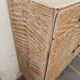 Vintage woven rattan furniture with tapered legs.