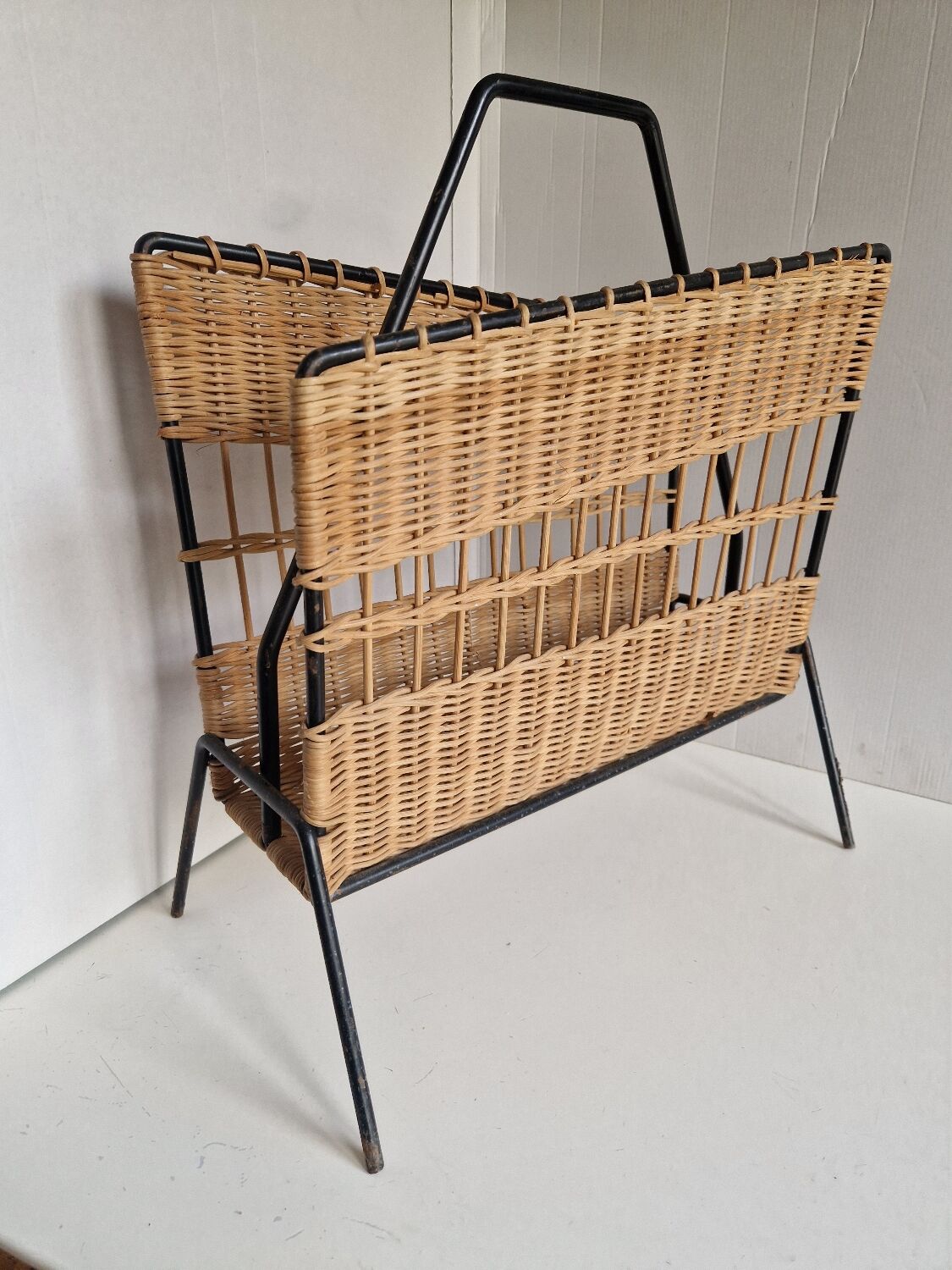 Raoul Guys magazine rack 1950s  
Rattan and black metal