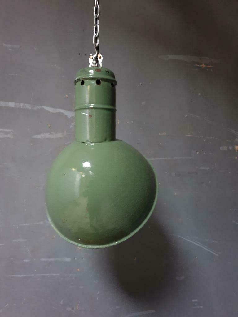 Old industrial enamel lamp in green