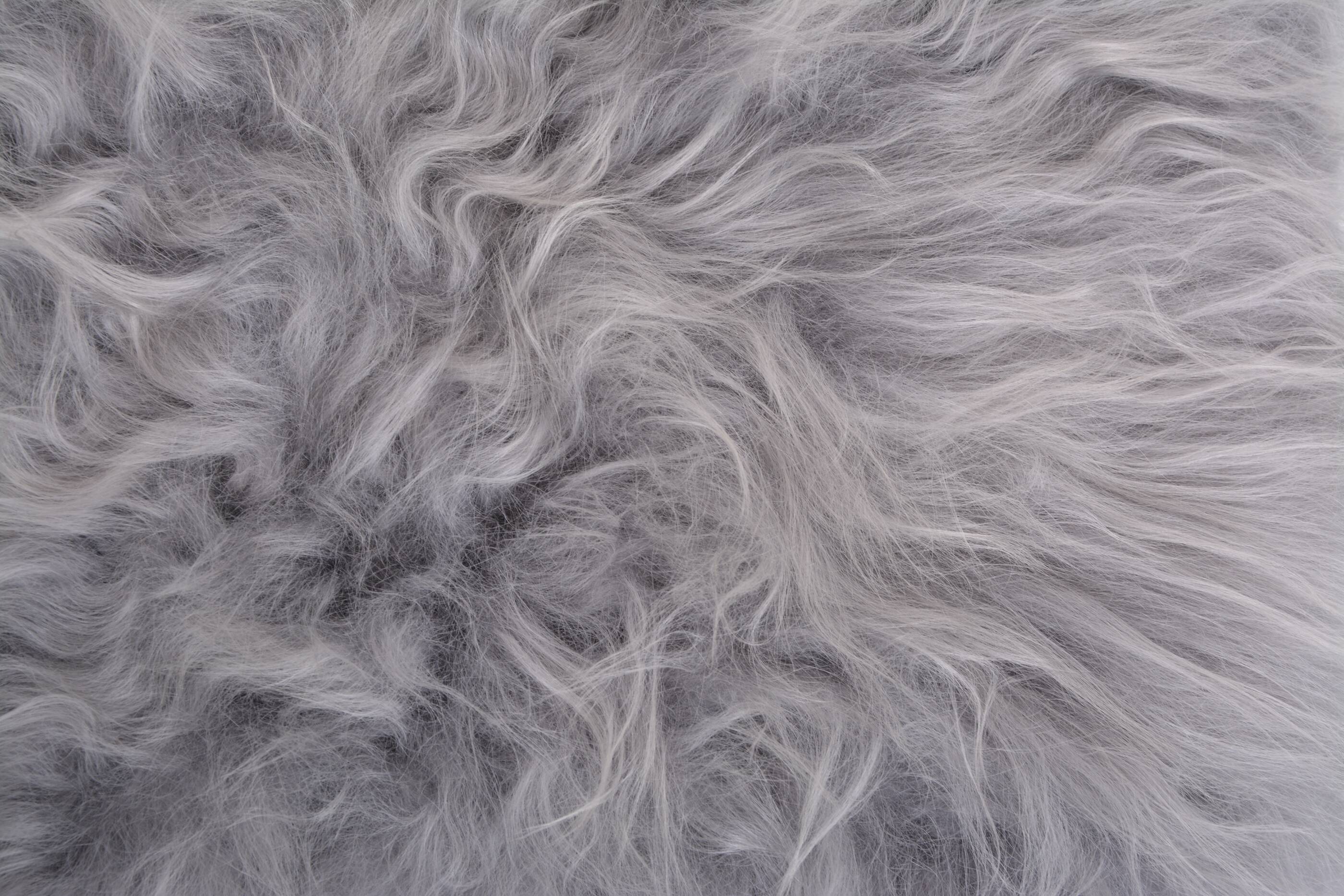 Danish Mid-century Modern stool reupholstered in grey sheep skin