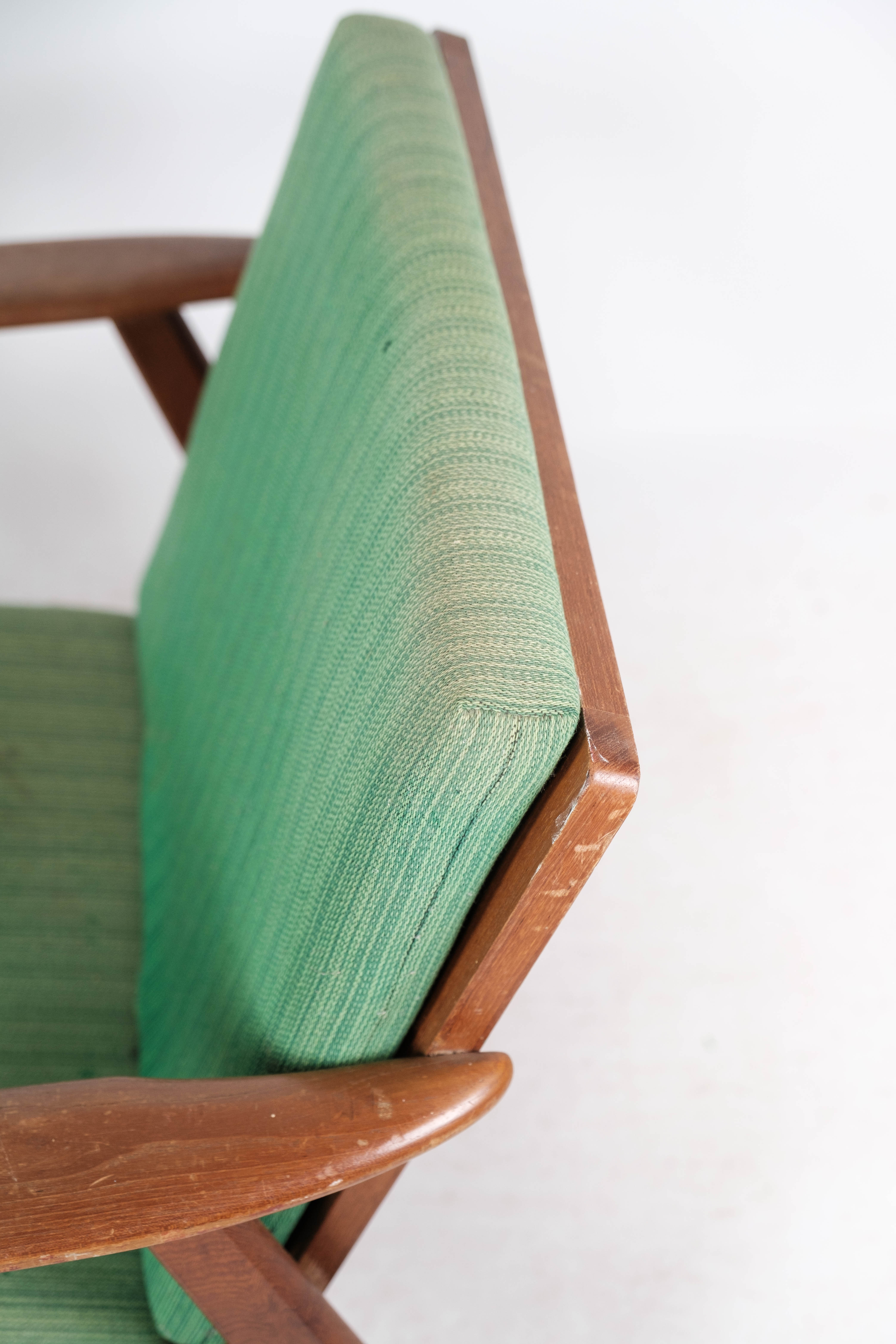 Easy chair in teak and with green upholstery of Danish design, 1960s
