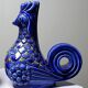 Pair of ceramic glazed candlesticks in the shape of roosters, signed A.G Roger, year 1948.