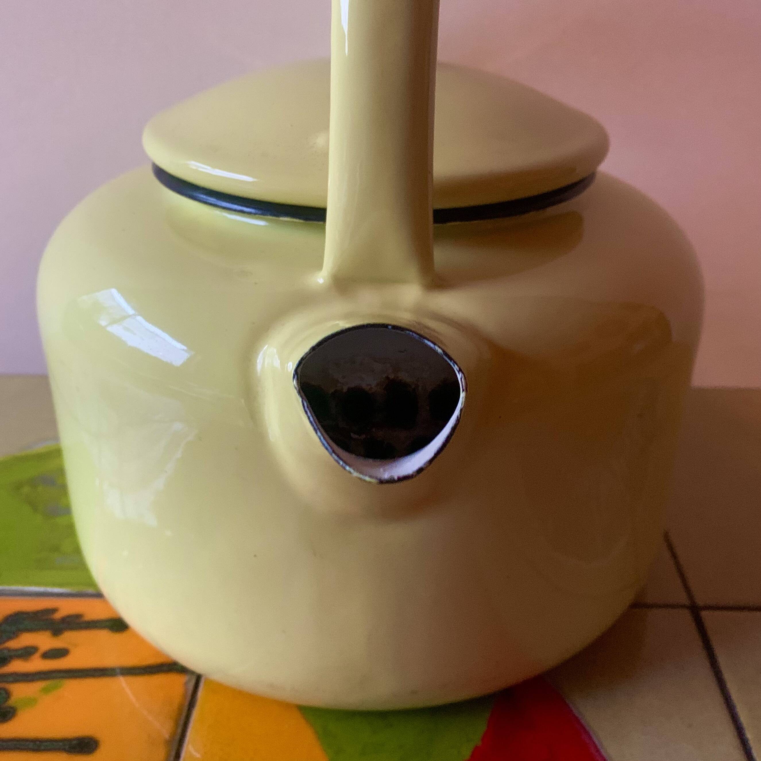 Old kettle in yellow enamelled sheet metal and Bakelite