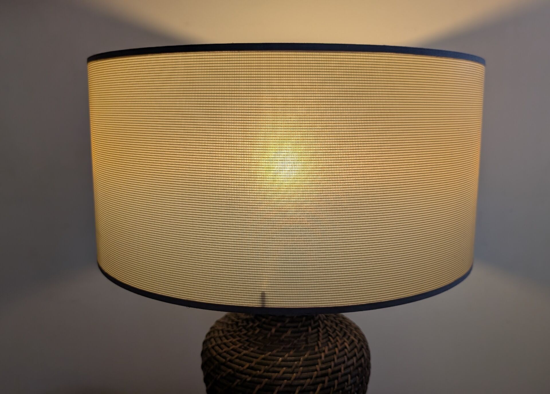 Vintage lamp in brown rattan with textured lampshade.