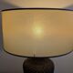 Vintage lamp in brown rattan with textured lampshade.