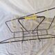 Black metal magazine rack with yellow scoubidou wire.