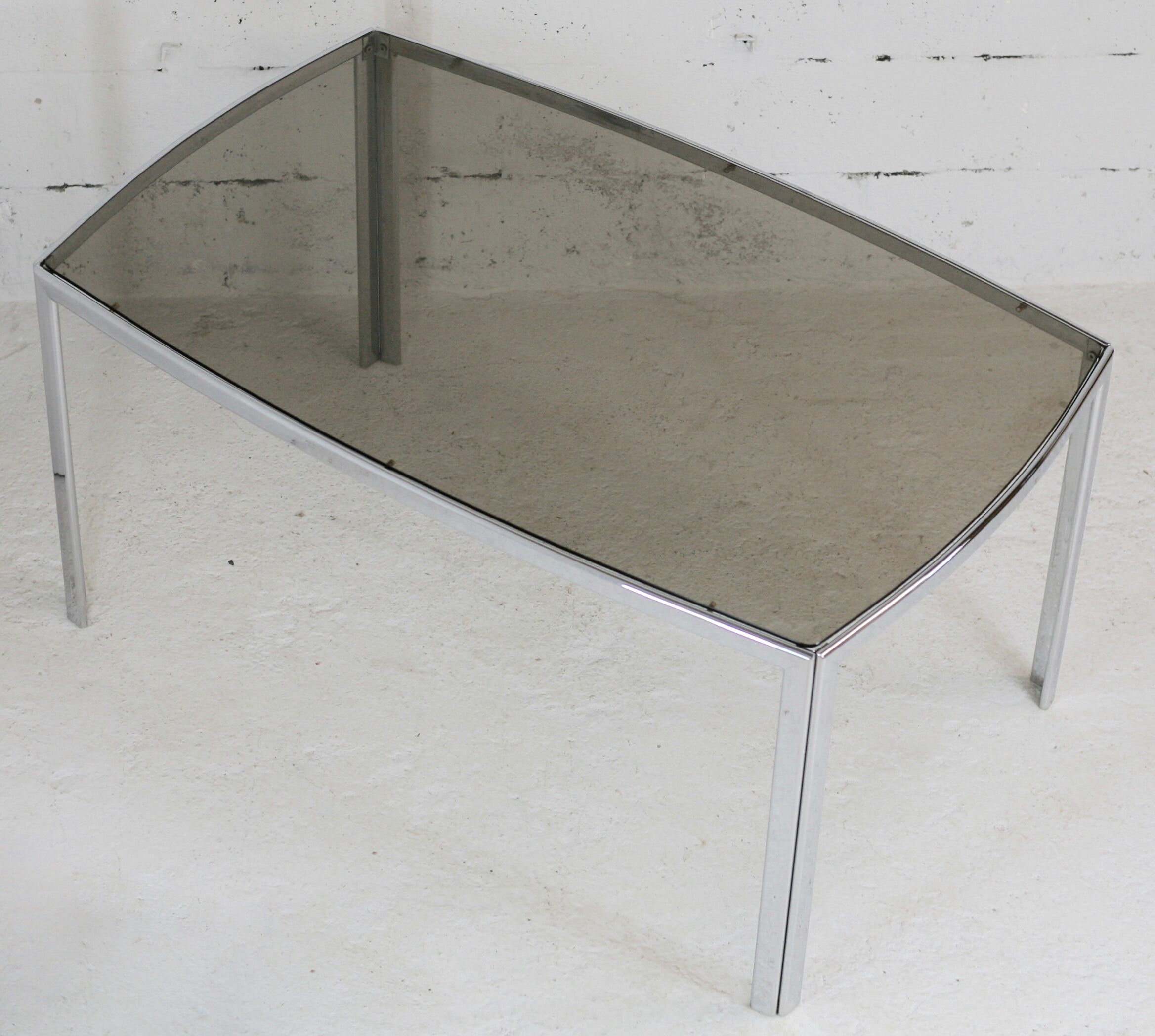 Living table. chrome metal, curved smoked glass slab, france, circa 1970.