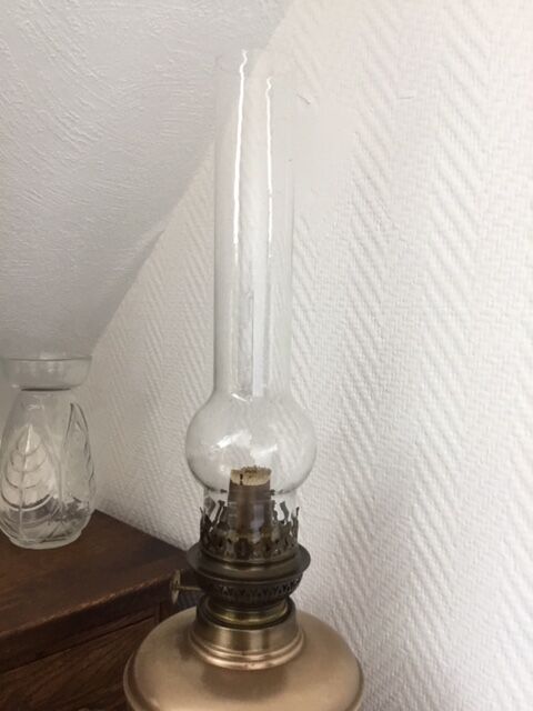 Old oil lamp on pink copper stand
