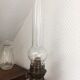 Old oil lamp on pink copper stand
