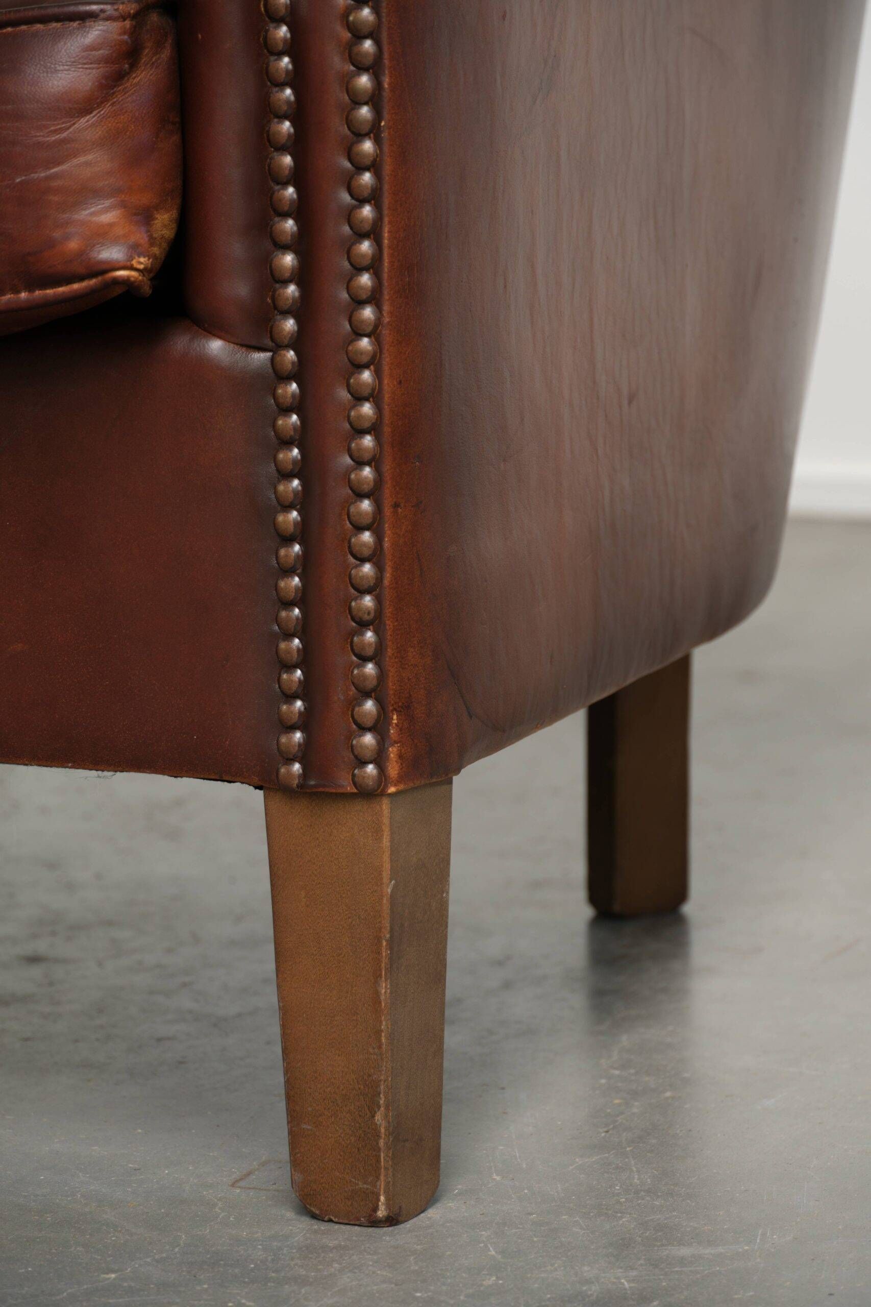 Set of 2 sheepskin club armchairs in a dark cognac colour