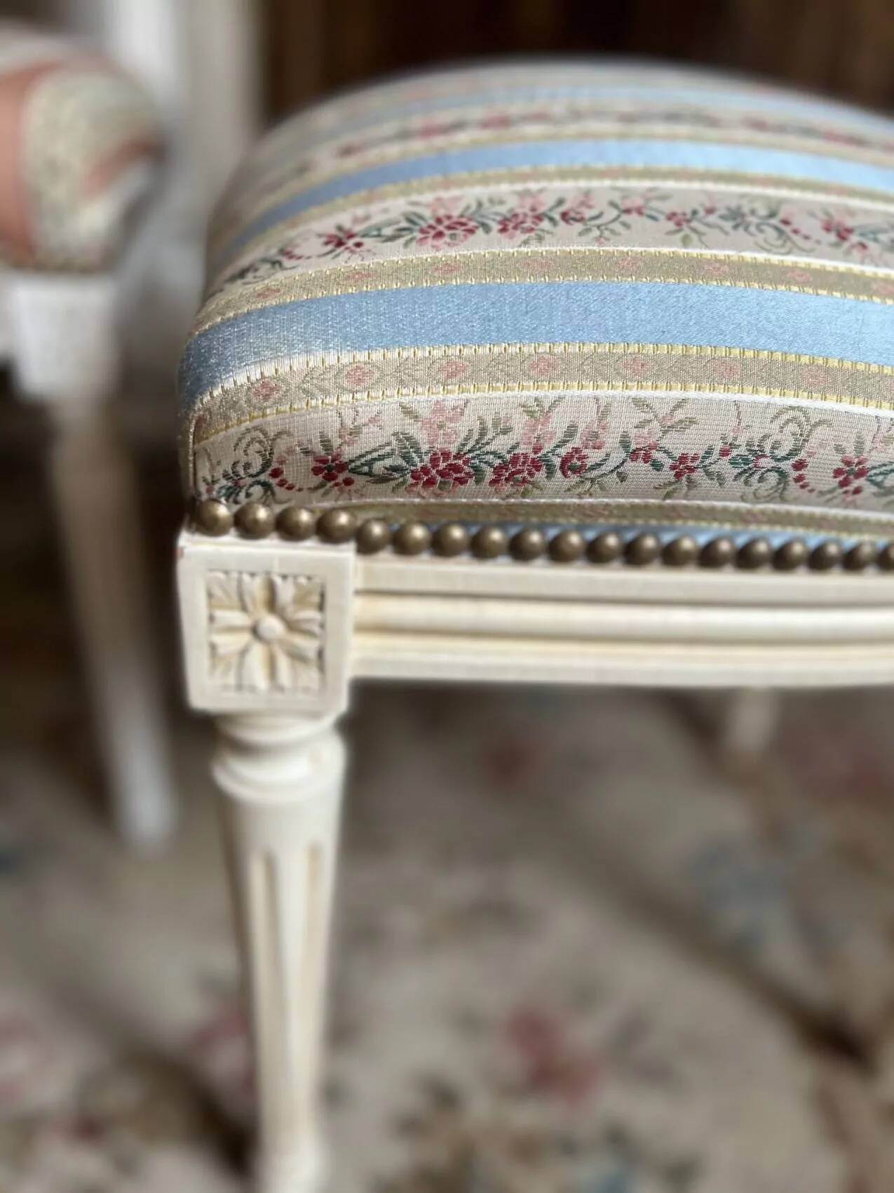Pair of Louis XVI style chairs in painted wood and satin, classic elegance.