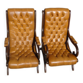 Wooden and upholstered leather armchairs, both.