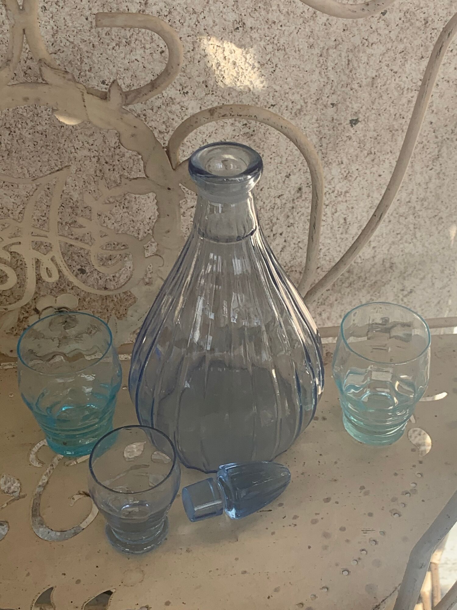 Liquor service consisting of a blue glass decanter and. 3 small antique glasses