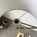 Floor lamp with articulated arm in brass-plated metal