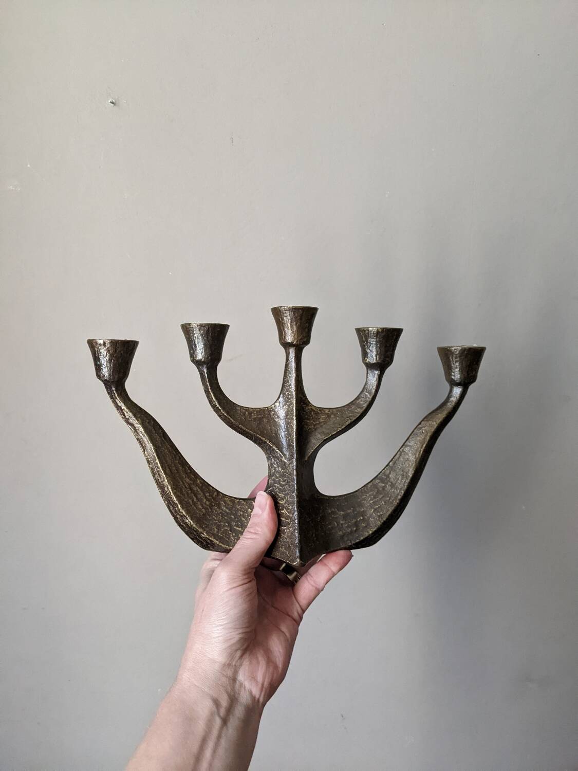 Vintage bronze candlestick chandelier in contemporary Scandinavian design.