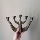 Vintage bronze candlestick chandelier in contemporary Scandinavian design.