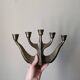 Vintage bronze candlestick chandelier in contemporary Scandinavian design.