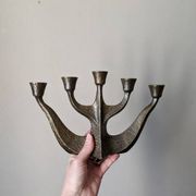 Vintage bronze candlestick chandelier in contemporary Scandinavian design.