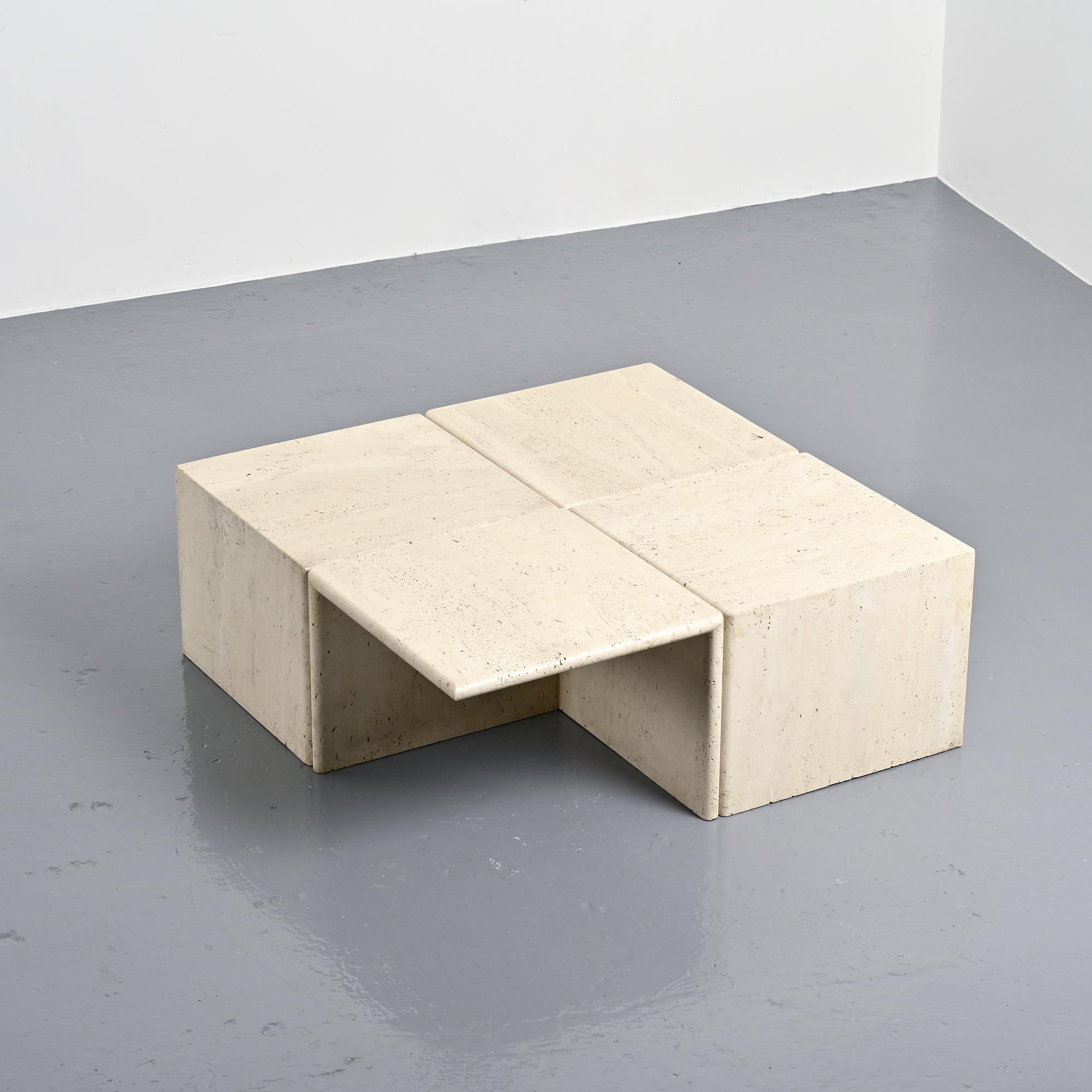 Set of four side tables in travertine, Italy, 1970s.